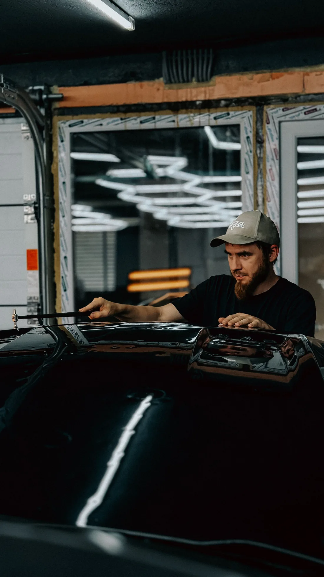 Automotive technician working carefully on a vehicle in a workshop
